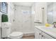 Elegant bathroom features a tiled shower, modern fixtures, and ample lighting at 515 9Th St, Winter Garden, FL 34787