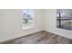 Cozy bedroom featuring hardwood floors, neutral paint, and bright windows at 515 9Th St, Winter Garden, FL 34787