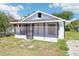 Charming single-story home with a screened porch and a well-maintained, small front yard at 515 9Th St, Winter Garden, FL 34787