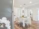 Well-lit kitchen with stainless steel appliances, a cozy dining area, and views into the bathroom at 515 9Th St, Winter Garden, FL 34787