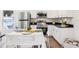 Contemporary kitchen featuring stainless steel appliances, sleek countertops, and a dining table for casual meals at 515 9Th St, Winter Garden, FL 34787