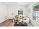 Inviting living room featuring a couch and bright windows, complemented by modern decor and light wood floors at 515 9Th St, Winter Garden, FL 34787