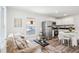 Open-concept living and kitchen area with stainless steel appliances and a dining table, filled with natural light at 515 9Th St, Winter Garden, FL 34787
