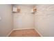 Walk-in closet with neutral carpet, wire shelving, with clothing items, and wall switch at 1010 Foreshore Ln, Haines City, FL 33844