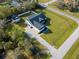 Areal view of a single-Gathering home featuring a classic white exterior, dark shutters, a welcoming porch, and a spacious lawn at 5118 Norriswood Dr, Mulberry, FL 33860