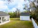 Expansive backyard with a detached garage and a screened-in lanai at 5118 Norriswood Dr, Mulberry, FL 33860