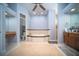 Spacious bathroom with a soaking tub, dual vanities and decorative tile at 5118 Norriswood Dr, Mulberry, FL 33860