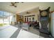 Relaxing screened patio with seating area, TV, and ceiling fans at 5118 Norriswood Dr, Mulberry, FL 33860