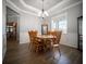 The dining room features wood flooring, a large window, crown molding, and wainscotting at 5118 Norriswood Dr, Mulberry, FL 33860