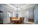 Traditional dining room with wood table, chairs, crown molding, and staircase access at 5118 Norriswood Dr, Mulberry, FL 33860