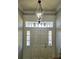 Bright entryway featuring an elegant light fixture and a sidelight front door, enhancing the home's appeal at 5118 Norriswood Dr, Mulberry, FL 33860