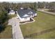 A pristine white home boasts a well-manicured lawn and a separate garage, enhancing its curb appeal at 5118 Norriswood Dr, Mulberry, FL 33860