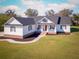 Attractive single-Gathering home featuring a classic white exterior, dark shutters, a welcoming porch, and a lush green lawn at 5118 Norriswood Dr, Mulberry, FL 33860