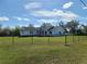Attractive single-story home with well-maintained lawn and a sturdy black perimeter fence at 5118 Norriswood Dr, Mulberry, FL 33860
