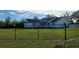Inviting view of a house from yard behind a sturdy black perimeter fence at 5118 Norriswood Dr, Mulberry, FL 33860