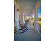 Comfortable front porch featuring rocking chairs, porch swings, and elegant columns for relaxing outdoor living at 5118 Norriswood Dr, Mulberry, FL 33860