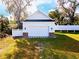 Exterior view of detached garage featuring white siding and clean design at 5118 Norriswood Dr, Mulberry, FL 33860