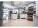 Open-concept kitchen with white cabinets, stainless steel appliances, and a tile floor at 5118 Norriswood Dr, Mulberry, FL 33860