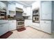 Bright kitchen featuring white cabinetry, stainless steel appliances, and tile flooring at 5118 Norriswood Dr, Mulberry, FL 33860