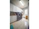 Well-equipped laundry room with modern appliances, cabinets, and a sink for convenience at 5118 Norriswood Dr, Mulberry, FL 33860