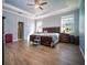 Spacious main bedroom featuring wood floors, a tray ceiling, and ample natural light at 5118 Norriswood Dr, Mulberry, FL 33860