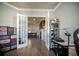 This home office transitions to the Gathering room, showcasing the wood flooring and neutral walls at 5118 Norriswood Dr, Mulberry, FL 33860