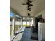 View of the screened-in patio with ceiling fans and outdoor furnishings at 5118 Norriswood Dr, Mulberry, FL 33860