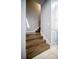 Stairway with wood steps and white risers, leading to the upper level at 5118 Norriswood Dr, Mulberry, FL 33860