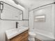 Modern bathroom showcasing black fixtures, bathtub with subway tile, and wood vanity at 720 W 14Th St, Lakeland, FL 33805