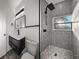 Modern bathroom featuring sleek black fixtures and eye-catching geometric patterned shower tiles at 720 W 14Th St, Lakeland, FL 33805
