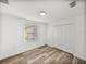 Bedroom with wood-look floors, natural light, and a double door closet at 720 W 14Th St, Lakeland, FL 33805