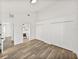 Large bedroom featuring wood-look floors, bathroom access, and double closets at 720 W 14Th St, Lakeland, FL 33805
