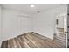 Bedroom featuring wood-look floors, closet, and view to hall and bathroom at 720 W 14Th St, Lakeland, FL 33805