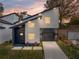 Charming two-story home featuring a modern design with a garage, black trim, xeriscaping, and a walkway to the entrance at 720 W 14Th St, Lakeland, FL 33805
