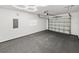 Spacious garage with overhead door, painted concrete floor, and unique hexagon-shaped lighting at 720 W 14Th St, Lakeland, FL 33805