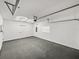 Bright garage with concrete floor, overhead door, and a modern, honeycomb-shaped ceiling light at 720 W 14Th St, Lakeland, FL 33805