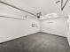 Clean garage featuring concrete floor, overhead door, white walls, and hexagon-shaped ceiling light at 720 W 14Th St, Lakeland, FL 33805