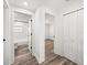 Bright hallway featuring wood-look flooring, a bathroom, closet, and a bedroom entrance at 720 W 14Th St, Lakeland, FL 33805