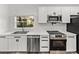 Modern kitchen featuring white cabinetry, stainless steel appliances, and a herringbone backsplash at 720 W 14Th St, Lakeland, FL 33805