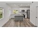 Modern kitchen featuring white cabinetry, stainless steel appliances, and a gray island with a white countertop at 720 W 14Th St, Lakeland, FL 33805