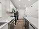 Modern kitchen featuring white cabinetry, stainless steel appliances, and a gray island with a white countertop at 720 W 14Th St, Lakeland, FL 33805