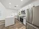 Modern kitchen featuring white cabinetry, stainless steel appliances, and a gray island with a white countertop at 720 W 14Th St, Lakeland, FL 33805