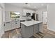 Modern kitchen featuring white cabinetry, stainless steel appliances, and a gray island with a white countertop at 720 W 14Th St, Lakeland, FL 33805