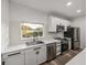 Modern kitchen featuring white cabinets, stainless steel appliances, and a bright view from the window at 720 W 14Th St, Lakeland, FL 33805