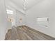 Spacious living area with soaring ceilings, wood-look flooring and a stylish light fixture at 720 W 14Th St, Lakeland, FL 33805