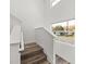 Bright staircase with wood stairs, white banisters and a street view through the window at 720 W 14Th St, Lakeland, FL 33805