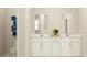 Bright bathroom showcasing a double vanity with white cabinetry, quartz countertops, and modern fixtures with simple decor at 759 Terrapin Dr, Debary, FL 32713
