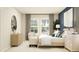 Cozy bedroom with neutral tones, accentuated by a navy wall, featuring a large window and minimalist decor elements at 759 Terrapin Dr, Debary, FL 32713