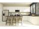 Modern, light-filled kitchen with stainless steel appliances and sleek white cabinetry at 759 Terrapin Dr, Debary, FL 32713