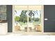 Outdoor patio view through sliding glass doors, showing a cozy seating area amidst a lush green landscape at 759 Terrapin Dr, Debary, FL 32713
